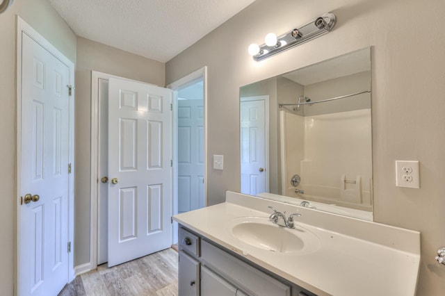 1716 Golden Valley Dr, Christiana, TN 37037 - bathroom with wood finished floors, vanity, a textured ceiling, and shower / tub combination
