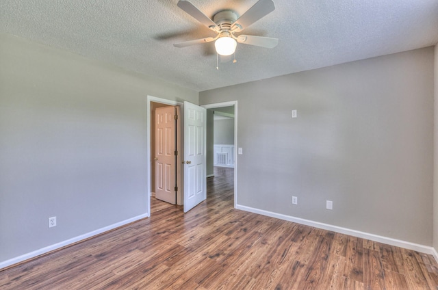 1716 Golden Valley Dr, Christiana, TN 37037 - spare room featuring baseboards, a ceiling fan, wood finished floors, and a textured ceiling