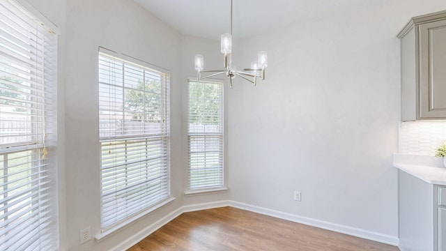 2014 Patrick Way, Spring Hill, TN 37174 - unfurnished dining area with a chandelier, wood finished floors, and baseboards