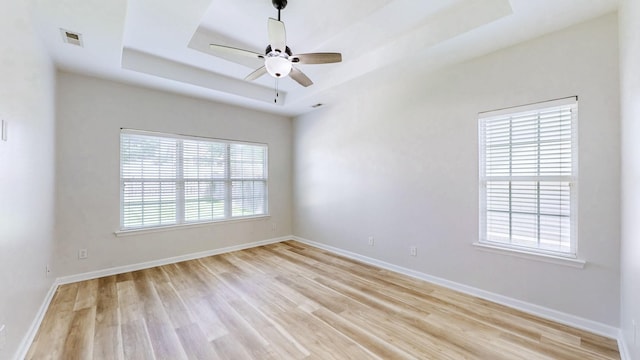 2014 Patrick Way, Spring Hill, TN 37174 - spare room featuring light wood-style flooring, a tray ceiling, baseboards, and a ceiling fan