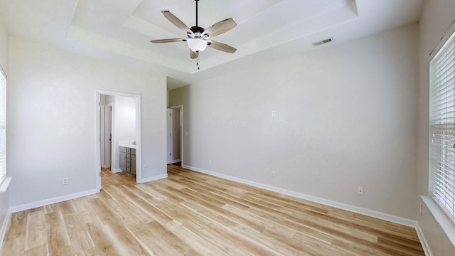 2014 Patrick Way, Spring Hill, TN 37174 - unfurnished bedroom with a raised ceiling, light wood-type flooring, multiple windows, and baseboards