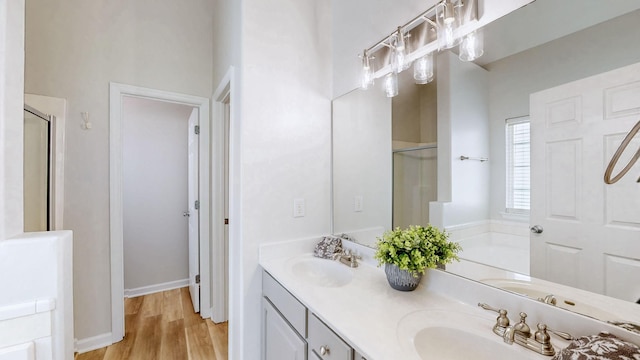 2014 Patrick Way, Spring Hill, TN 37174 - bathroom featuring a stall shower, wood finished floors, a bath, and double vanity