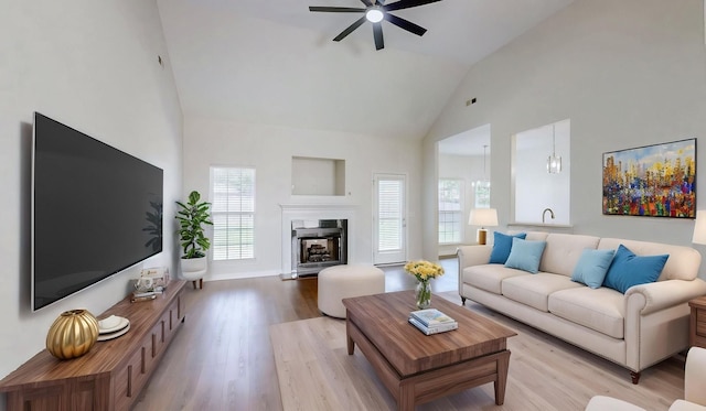 2014 Patrick Way, Spring Hill, TN 37174 - living area with high vaulted ceiling, a ceiling fan, light wood finished floors, and a fireplace with raised hearth