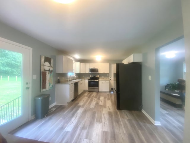148 Shawna Ln, Hillsboro, TN 37342 - kitchen featuring stainless steel appliances, light wood-style floors, light countertops, and white cabinets