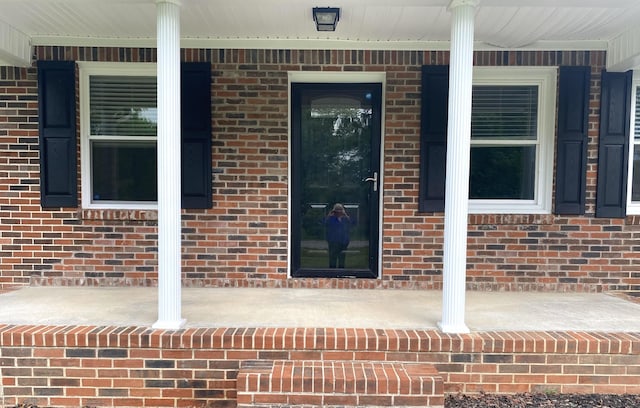 148 Shawna Ln, Hillsboro, TN 37342 - doorway to property featuring covered porch and brick siding