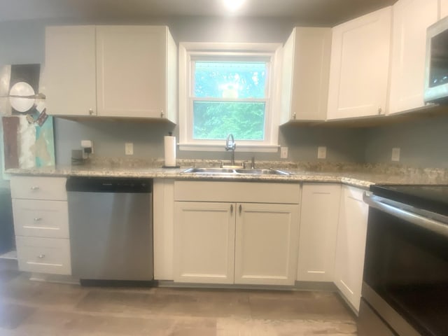 148 Shawna Ln, Hillsboro, TN 37342 - kitchen featuring dishwasher, stove, a sink, and white cabinets