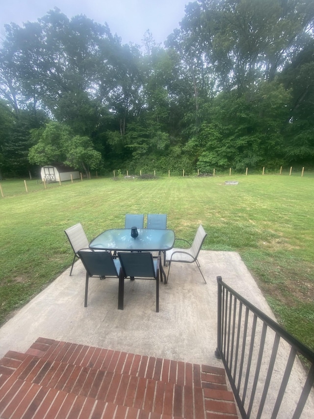 148 Shawna Ln, Hillsboro, TN 37342 - view of patio / terrace with outdoor dining area, a storage unit, and an outbuilding