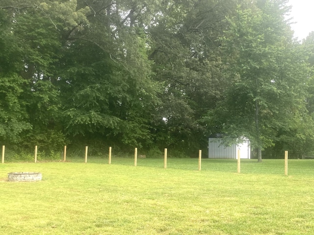 148 Shawna Ln, Hillsboro, TN 37342 - view of grassy yard with an outdoor structure, a fire pit, and a shed