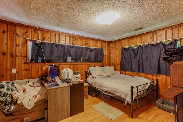 3913 Pickering Ave, Chattanooga, TN 37415 - bedroom with light wood finished floors, a textured ceiling, and wooden walls