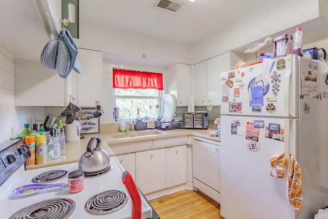 3913 Pickering Ave, Chattanooga, TN 37415 - kitchen with white appliances, light countertops, white cabinets, and a sink