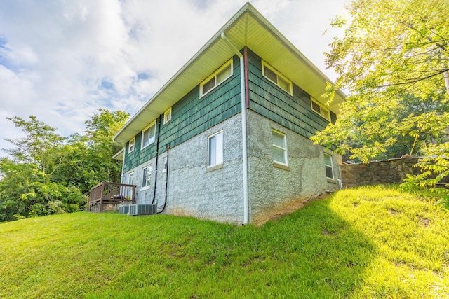 3913 Pickering Ave, Chattanooga, TN 37415 - view of side of home with a lawn, central air condition unit, stucco siding, and a deck