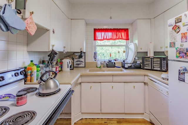 3913 Pickering Ave, Chattanooga, TN 37415 - kitchen featuring white appliances, a sink, light countertops, backsplash, and white cabinets