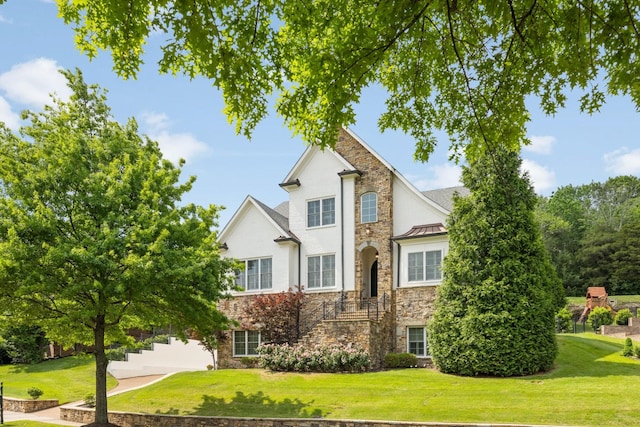 109 Allenhurst Cir, Franklin, TN 37067 - view of front facade featuring stone siding, a front yard, a standing seam roof, and stairs