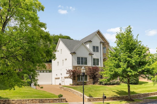 109 Allenhurst Cir, Franklin, TN 37067 - traditional-style house with an attached garage, stone siding, driveway, a front yard, and stucco siding