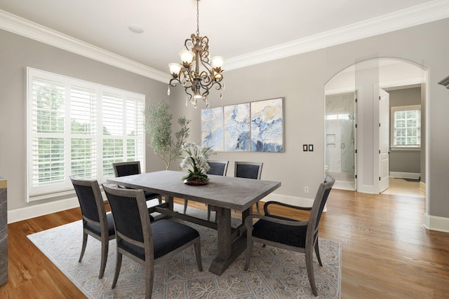 109 Allenhurst Cir, Franklin, TN 37067 - dining space with ornamental molding, arched walkways, a chandelier, wood finished floors, and baseboards