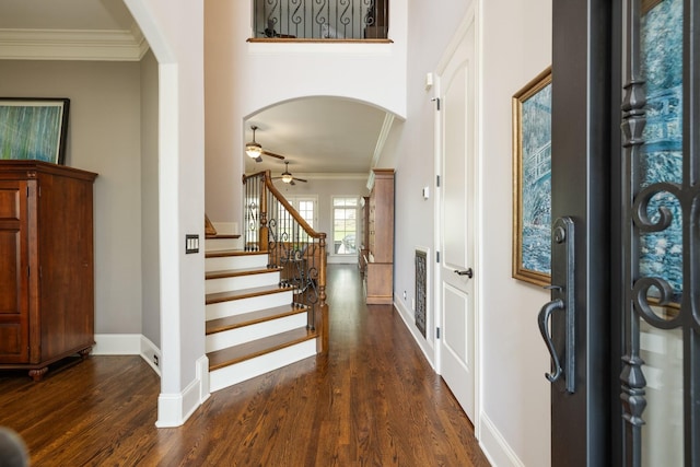 109 Allenhurst Cir, Franklin, TN 37067 - entrance foyer featuring arched walkways, ornamental molding, dark wood-type flooring, baseboards, and stairway