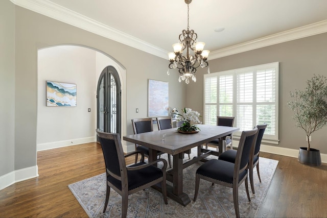 109 Allenhurst Cir, Franklin, TN 37067 - dining area featuring ornamental molding, baseboards, a chandelier, arched walkways, and dark wood-type flooring