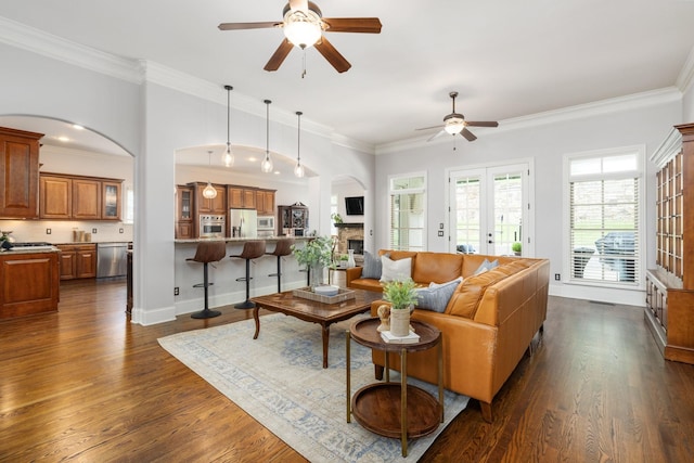 109 Allenhurst Cir, Franklin, TN 37067 - living area featuring ceiling fan, arched walkways, a fireplace, dark wood-style floors, and ornamental molding
