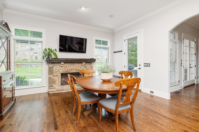 109 Allenhurst Cir, Franklin, TN 37067 - dining room featuring wood finished floors, arched walkways, crown molding, a fireplace, and baseboards