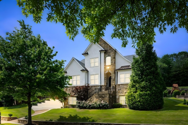 109 Allenhurst Cir, Franklin, TN 37067 - view of front facade featuring stone siding, a front yard, a standing seam roof, stucco siding, and stairs