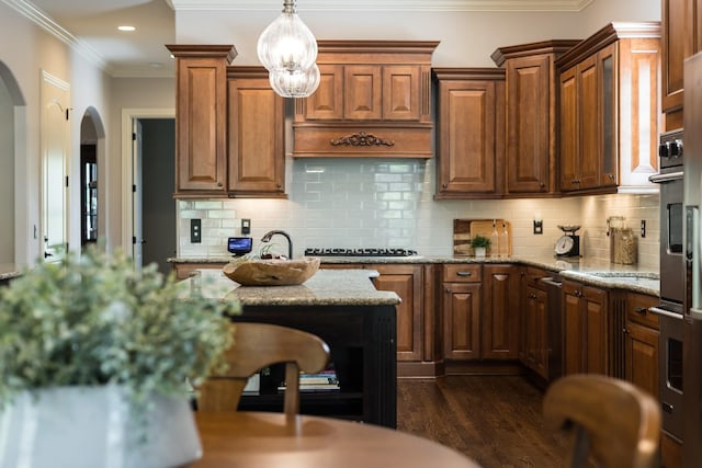 109 Allenhurst Cir, Franklin, TN 37067 - kitchen with arched walkways, dark wood-style flooring, light stone countertops, recessed lighting, and tasteful backsplash