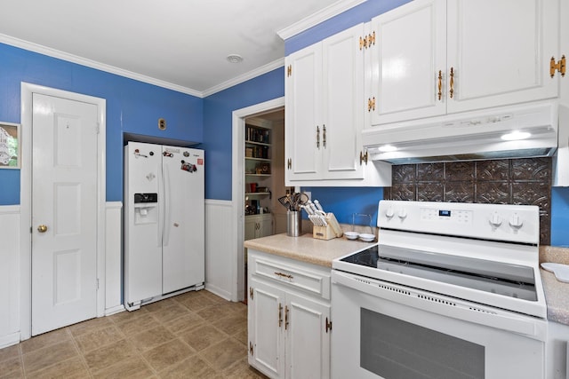 1403 Manor Rd, Columbia, TN 38401 - kitchen with white appliances, under cabinet range hood, light countertops, white cabinets, and wainscoting