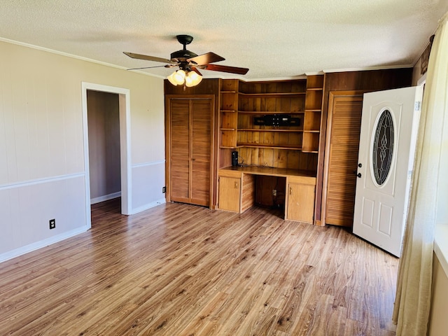 202 Tomlinson Rd, Lebanon, TN 37087 - unfurnished living room featuring ornamental molding, light wood-style flooring, a ceiling fan, a textured ceiling, and baseboards