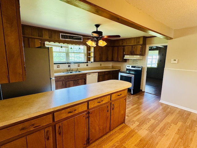 202 Tomlinson Rd, Lebanon, TN 37087 - kitchen with electric range, under cabinet range hood, a sink, light wood-style floors, and light countertops