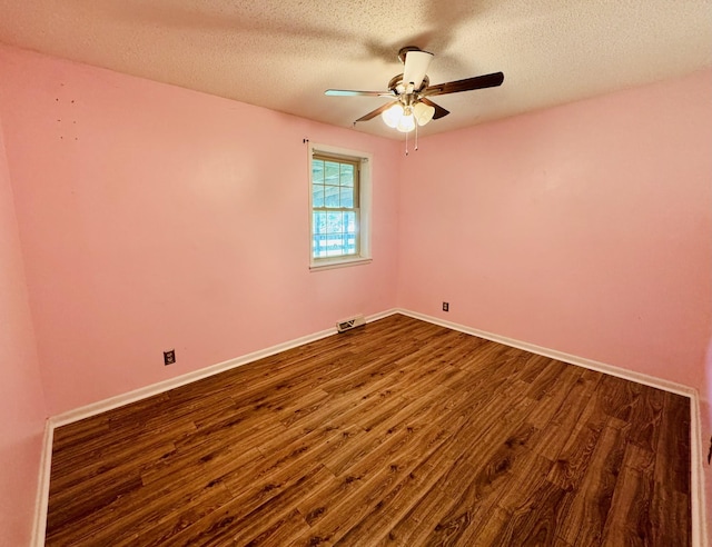 202 Tomlinson Rd, Lebanon, TN 37087 - spare room featuring dark wood finished floors, a textured ceiling, a ceiling fan, and baseboards