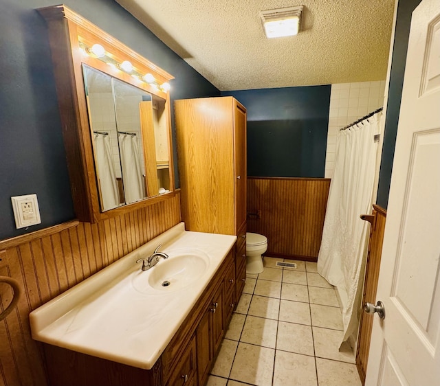 202 Tomlinson Rd, Lebanon, TN 37087 - full bathroom featuring a textured ceiling, wainscoting, vanity, toilet, and tile patterned floors