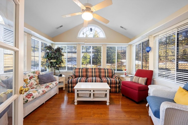 sunroom / solarium featuring lofted ceiling and wood finished floors