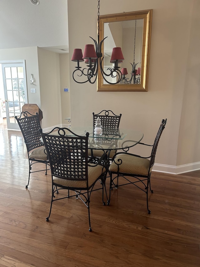 dining space featuring wood finished floors and baseboards