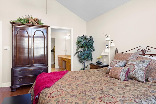 bedroom with lofted ceiling, wood finished floors, ensuite bath, and baseboards