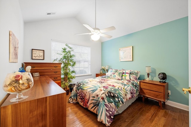 bedroom with wood finished floors, lofted ceiling, a ceiling fan, and baseboards