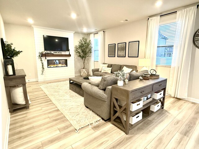 4524 Hoboken Way, Murfreesboro, TN 37128 - living room featuring a glass covered fireplace, light wood-style flooring, plenty of natural light, recessed lighting, and baseboards