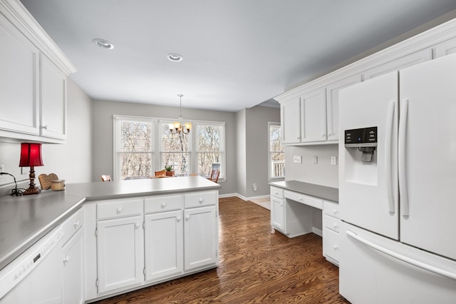 6716 Autumnwood Dr, Nashville, TN 37221 - kitchen with white appliances, a peninsula, dark wood-style flooring, white cabinetry, and recessed lighting