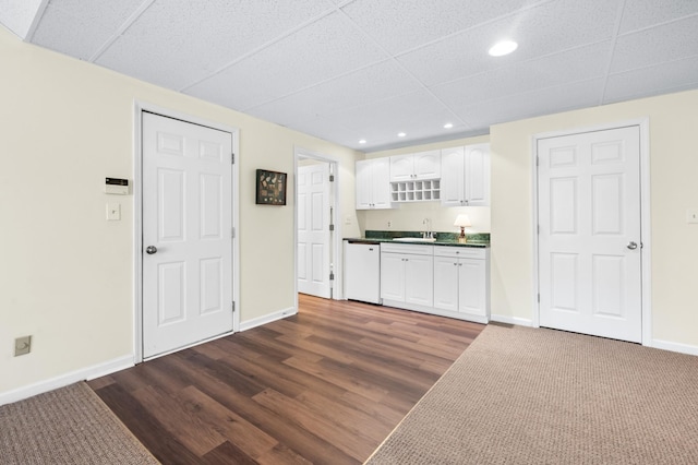 6716 Autumnwood Dr, Nashville, TN 37221 - kitchen with dishwasher, a sink, dark countertops, a drop ceiling, and white cabinets