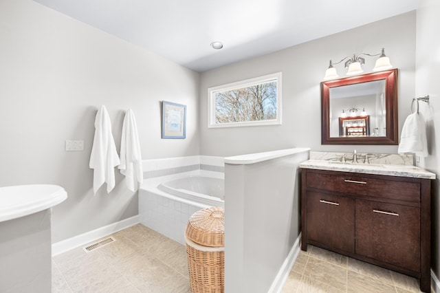 6716 Autumnwood Dr, Nashville, TN 37221 - bathroom with a garden tub, vanity, baseboards, and tile patterned flooring
