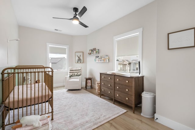 178 Charleston Ave, Pleasant View, TN 37146 - bedroom with wood finished floors, a crib, baseboards, and a ceiling fan