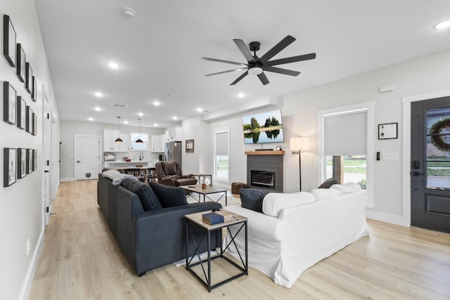 178 Charleston Ave, Pleasant View, TN 37146 - living area featuring light wood-type flooring, ceiling fan, a glass covered fireplace, baseboards, and recessed lighting