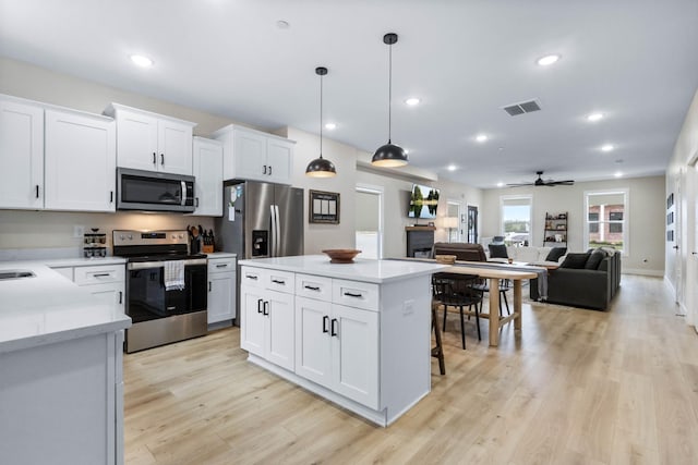 178 Charleston Ave, Pleasant View, TN 37146 - kitchen with appliances with stainless steel finishes, light countertops, ceiling fan, light wood finished floors, and hanging light fixtures