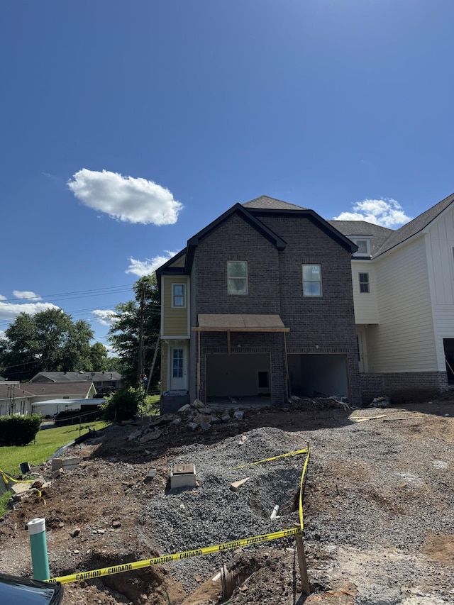 601 Galaxie Dr, Nashville, TN 37209 - rear view of property featuring a garage and brick siding