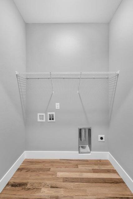 1587 Adams St, Chattanooga, TN 37408 - laundry area featuring electric dryer hookup, washer hookup, baseboards, and wood finished floors