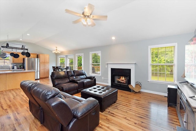 2129 Hollandale Cir, Columbia, TN 38401 - living area with vaulted ceiling, light wood-type flooring, a fireplace with flush hearth, ceiling fan, and baseboards