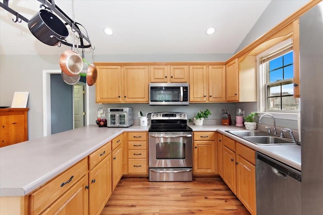 2129 Hollandale Cir, Columbia, TN 38401 - kitchen featuring appliances with stainless steel finishes, a sink, light wood-style floors, light countertops, and recessed lighting