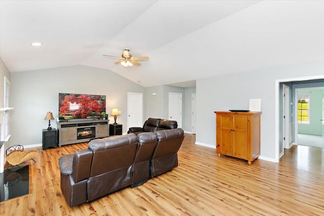 2129 Hollandale Cir, Columbia, TN 38401 - living room featuring a warm lit fireplace, light wood-type flooring, ceiling fan, baseboards, and lofted ceiling