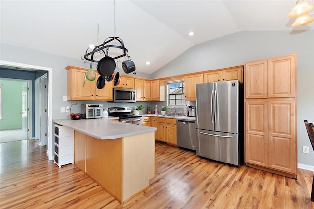 2129 Hollandale Cir, Columbia, TN 38401 - kitchen with appliances with stainless steel finishes, light brown cabinets, lofted ceiling, a sink, and a peninsula