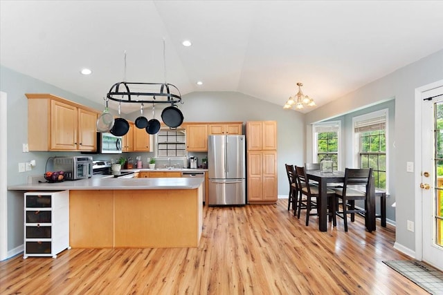 2129 Hollandale Cir, Columbia, TN 38401 - kitchen featuring stainless steel appliances, light brown cabinets, a peninsula, light countertops, and lofted ceiling