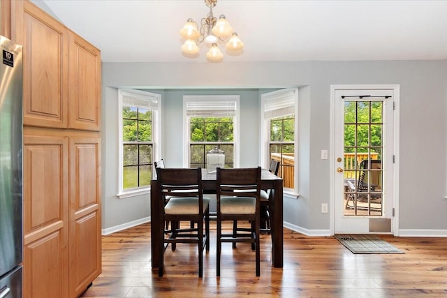 2129 Hollandale Cir, Columbia, TN 38401 - dining area with a chandelier, wood finished floors, and baseboards