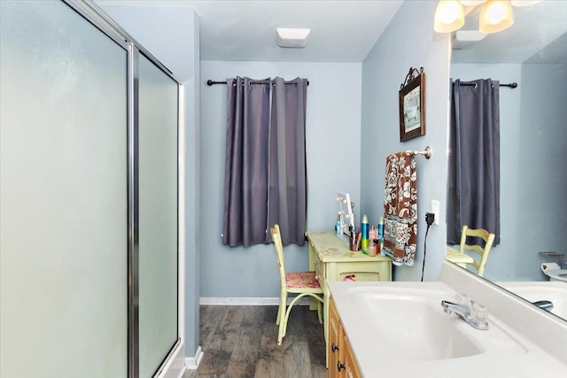 2129 Hollandale Cir, Columbia, TN 38401 - bathroom featuring a stall shower, vanity, wood finished floors, and baseboards